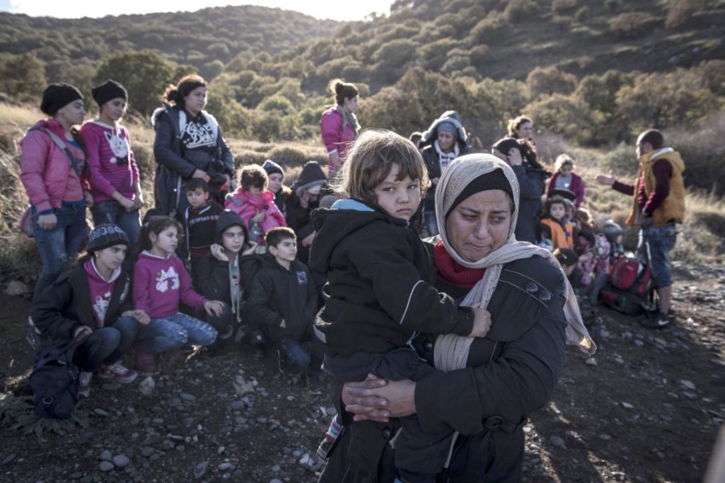A Yazidi woman from the Sinjar district of Iraq holds her child after arriving by boat from the Turkish coast on the island of Lesbos, Greece, Nov. 26, 2015. (SERGEY PONOMAREV / THE NEW YORK TIMES) 