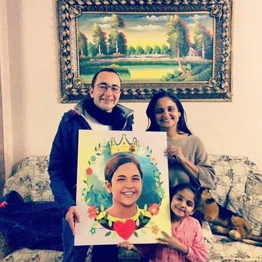 Maggie's Family holding her picture