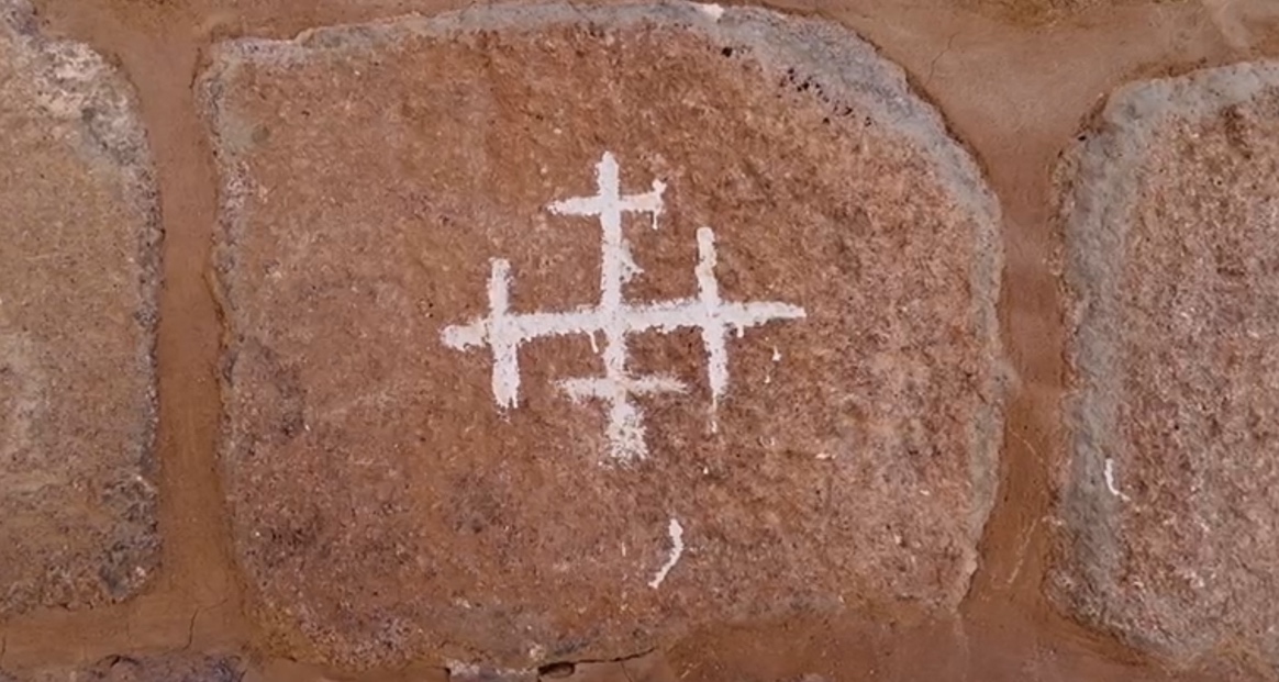 A white cross on a rock

AI-generated content may be incorrect.